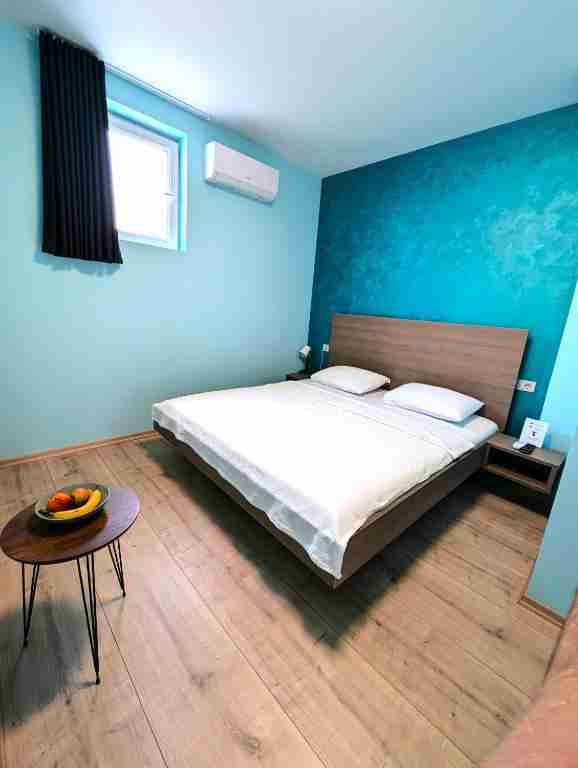 Modern bedroom in Kumanovo apartment with comfortable bed and clean interior design